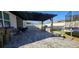 Outdoor patio with a covered pergola, outdoor kitchen, stone counters, and ample seating area at 5340 Jubiloso Dr, St Cloud, FL 34771
