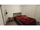 Simple bedroom with a red bedspread, nightstands, and a door to the side at 5340 Jubiloso Dr, St Cloud, FL 34771