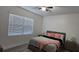 Well-lit bedroom with a king bed, neutral tones, and a large window at 5340 Jubiloso Dr, St Cloud, FL 34771
