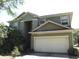 Charming two-story home featuring an attached two-car garage and well-maintained landscaping at 563 Lake Davenport Cir, Davenport, FL 33837