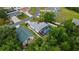 Aerial view showing a home with a screened-in pool area and lush backyard with mature trees around the property at 572 Nogales Ct, Kissimmee, FL 34758