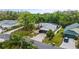 An aerial view showcases a well-maintained house featuring verdant landscaping, complemented by a pool and an extended screened-in lanai at 572 Nogales Ct, Kissimmee, FL 34758