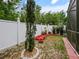 Landscaped backyard with white fence and decorative red mulch at 572 Nogales Ct, Kissimmee, FL 34758