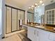 Bathroom featuring granite counters, modern vanity, and glass enclosed shower at 572 Nogales Ct, Kissimmee, FL 34758