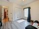Bright bedroom featuring modern flooring, window with stylish decorations, and closet at 572 Nogales Ct, Kissimmee, FL 34758