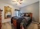 Bedroom featuring a ceiling fan, wood-look floors, decorative headboard, and natural light at 572 Nogales Ct, Kissimmee, FL 34758