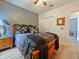 Bedroom with closet, ceiling fan, wood-look floors, and access to the bathroom at 572 Nogales Ct, Kissimmee, FL 34758