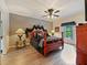 Bedroom featuring ceiling fan, wood-look floors, a decorative headboard, and natural light at 572 Nogales Ct, Kissimmee, FL 34758