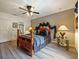 Bedroom featuring ceiling fan, wood-look floors, a decorative headboard, and closet at 572 Nogales Ct, Kissimmee, FL 34758