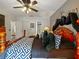 Bright bedroom featuring ceiling fan, wood-look floors, closet, and access to the bathroom at 572 Nogales Ct, Kissimmee, FL 34758