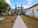 Inviting walkway leading to a home with manicured landscaping and decorative planters at 572 Nogales Ct, Kissimmee, FL 34758