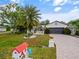 Charming home with well-manicured lawn, landscaped garden, and tiled driveway at 572 Nogales Ct, Kissimmee, FL 34758