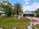 Beautiful home with a lush lawn, palm tree, and paved driveway at 572 Nogales Ct, Kissimmee, FL 34758