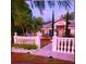 Charming home featuring decorative rock, tropical plants, landscape lighting, and a decorative fence at 572 Nogales Ct, Kissimmee, FL 34758