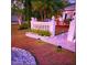 Charming home featuring decorative rock, tropical plants, landscape lighting, and a decorative fence at 572 Nogales Ct, Kissimmee, FL 34758