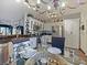 Open-concept kitchen with granite countertops, stainless steel appliances, and decorative lighting fixtures at 572 Nogales Ct, Kissimmee, FL 34758