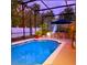 Inviting screened-in pool area with furniture, plants, patio and overhead lighting at 572 Nogales Ct, Kissimmee, FL 34758