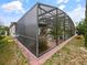 Screened pool enclosure, patio furniture, and mature tropical landscaping at 572 Nogales Ct, Kissimmee, FL 34758
