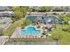 Aerial view of the community pool, clubhouse, and manicured landscaping for a relaxing atmosphere at 5912 Village Cir # Ge, Orlando, FL 32822
