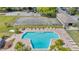 Aerial view of community pool, tennis court, and green spaces that enhances the overall lifestyle at 5912 Village Cir # Ge, Orlando, FL 32822