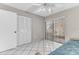 Cozy bedroom featuring tiled floors, a ceiling fan, closet and sliding glass doors at 5912 Village Cir # Ge, Orlando, FL 32822