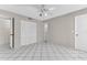 A bedroom featuring tiled flooring, a ceiling fan, and a closet with double doors at 5912 Village Cir # Ge, Orlando, FL 32822