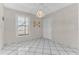 Bright dining area with white tile flooring, natural light, and a decorative chandelier at 5912 Village Cir # Ge, Orlando, FL 32822
