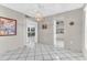 Open dining area with white tile, stylish lighting, and an open floor plan at 5912 Village Cir # Ge, Orlando, FL 32822