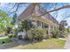 Charming townhouse exterior featuring classic architecture, a well-kept lawn, and mature landscaping at 5912 Village Cir # Ge, Orlando, FL 32822