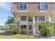 Inviting townhouse with a well maintained lawn and blooming bushes near the entryway at 5912 Village Cir # Ge, Orlando, FL 32822