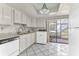 Well-lit kitchen with white cabinets, granite countertops, and modern appliances at 5912 Village Cir # Ge, Orlando, FL 32822