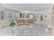 Bright living room featuring tile floors, neutral walls, and comfortable wicker furniture at 5912 Village Cir # Ge, Orlando, FL 32822