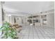 Spacious living room with tile flooring, a large mirrored wall, and bright, neutral tones at 5912 Village Cir # Ge, Orlando, FL 32822