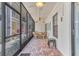 The enclosed patio features brick floors, a ceiling fan, a table with 4 chairs, and outdoor access at 5912 Village Cir # Ge, Orlando, FL 32822