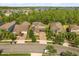 A beautiful aerial view of a neighborhood with well-maintained homes and a lake in the background at 6137 Waterside Island Ln, Winter Garden, FL 34787