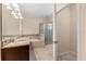 Bathroom featuring a double vanity, soaking tub, glass-enclosed shower, and neutral tile flooring at 6137 Waterside Island Ln, Winter Garden, FL 34787