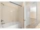 Bathroom shower with full bathtub and tile surround at 6137 Waterside Island Ln, Winter Garden, FL 34787
