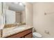 This bathroom features a granite countertop, neutral walls, and large mirror at 6137 Waterside Island Ln, Winter Garden, FL 34787