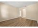 Bedroom featuring hardwood floors, neutral walls, and a doorway to the rest of the home at 6137 Waterside Island Ln, Winter Garden, FL 34787