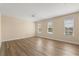 Spacious bedroom with hardwood floors and three windows offering plenty of natural light at 6137 Waterside Island Ln, Winter Garden, FL 34787
