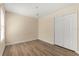 Bedroom featuring hardwood floors, neutral walls, and a window at 6137 Waterside Island Ln, Winter Garden, FL 34787