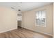 Bedroom featuring hardwood floors, neutral walls, and a window at 6137 Waterside Island Ln, Winter Garden, FL 34787