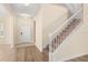 Inviting foyer with hardwood floors, staircase, and white front door at 6137 Waterside Island Ln, Winter Garden, FL 34787
