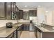 A kitchen features dark cabinets, stainless steel appliances, and granite countertops at 6137 Waterside Island Ln, Winter Garden, FL 34787