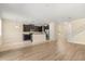 Open-concept living area with kitchen, breakfast nook, staircase, and hardwood floors at 6137 Waterside Island Ln, Winter Garden, FL 34787