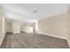 Spacious living room with hardwood floors, neutral walls, and ample space for various furniture arrangements at 6137 Waterside Island Ln, Winter Garden, FL 34787