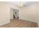Room with chandelier, neutral walls, and new wood floor leading to stairway at 6137 Waterside Island Ln, Winter Garden, FL 34787
