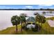 Aerial view of the lakefront property, featuring a gazebo and private dock at 6186 Oak Shore Dr, St Cloud, FL 34771