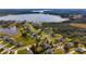 Overhead view of a residential neighborhood with lush landscapes, near a serene lake, showcasing a peaceful community at 6186 Oak Shore Dr, St Cloud, FL 34771