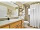Bathroom with granite counter vanity, walk-in shower with tiled walls and a linen closet at 6186 Oak Shore Dr, St Cloud, FL 34771